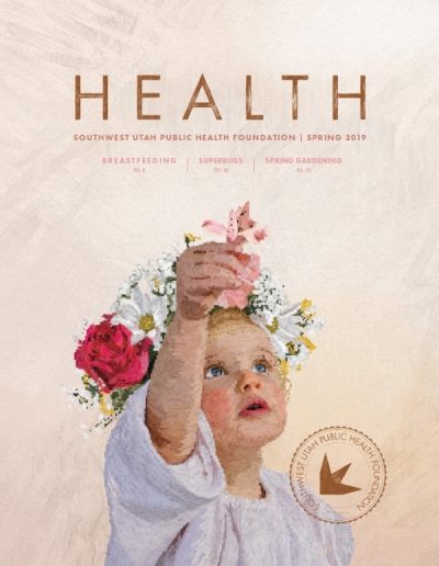 Front cover of "HEALTH" magazine by the Southwest Utah Public Health Foundation, Spring 2019 issue. The main illustration is a textured painterly portrait of a young toddler looking upward with blue eyes, wearing a large crown of white daisies and a red rose, holding a pink flower petal. The text near the top highlights articles on "Breastfeeding," "Superbugs," and "Spring Gardening." A circular stamp sits in the lower right corner.