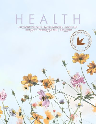 Front cover of "HEALTH" magazine by the Southwest Utah Public Health Foundation, Summer 2021 issue. The top features light purple typography listing articles on Heat Safety, Pandemic Volunteers, and an Annual Report. The lower half features a delicate watercolor-style illustration of wildflowers, including yellow cosmos, pink blossoms, and white daisies against a pale blue background. A circular foundation stamp is located on the right side.