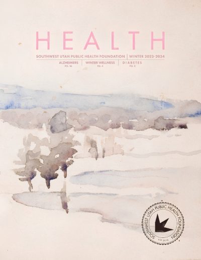 Front cover of "HEALTH" magazine by the Southwest Utah Public Health Foundation, Winter 2023-2024 issue. The pink title text at the top lists articles on Alzheimers, Winter Wellness, and Diabetes. The background is a soft, minimalist watercolor painting of a snow-covered winter landscape, featuring a cluster of bare, muted trees reflecting in a patch of water under a pale blue and grey sky. The circular foundation logo sits in the bottom right corner.
