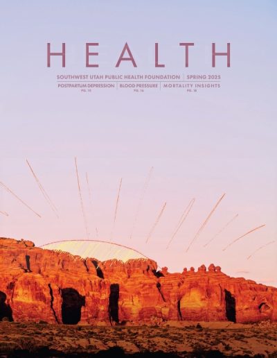 Magazine cover for HEALTH: Southwest Utah Public Health Foundation, Spring 2025, featuring a photograph of red rock formations glowing in the late afternoon sun. A stylized graphic of golden rays arches over the horizon against a pale purple sky. Featured articles include Postpartum Depression, Blood Pressure, and Mortality Insights.